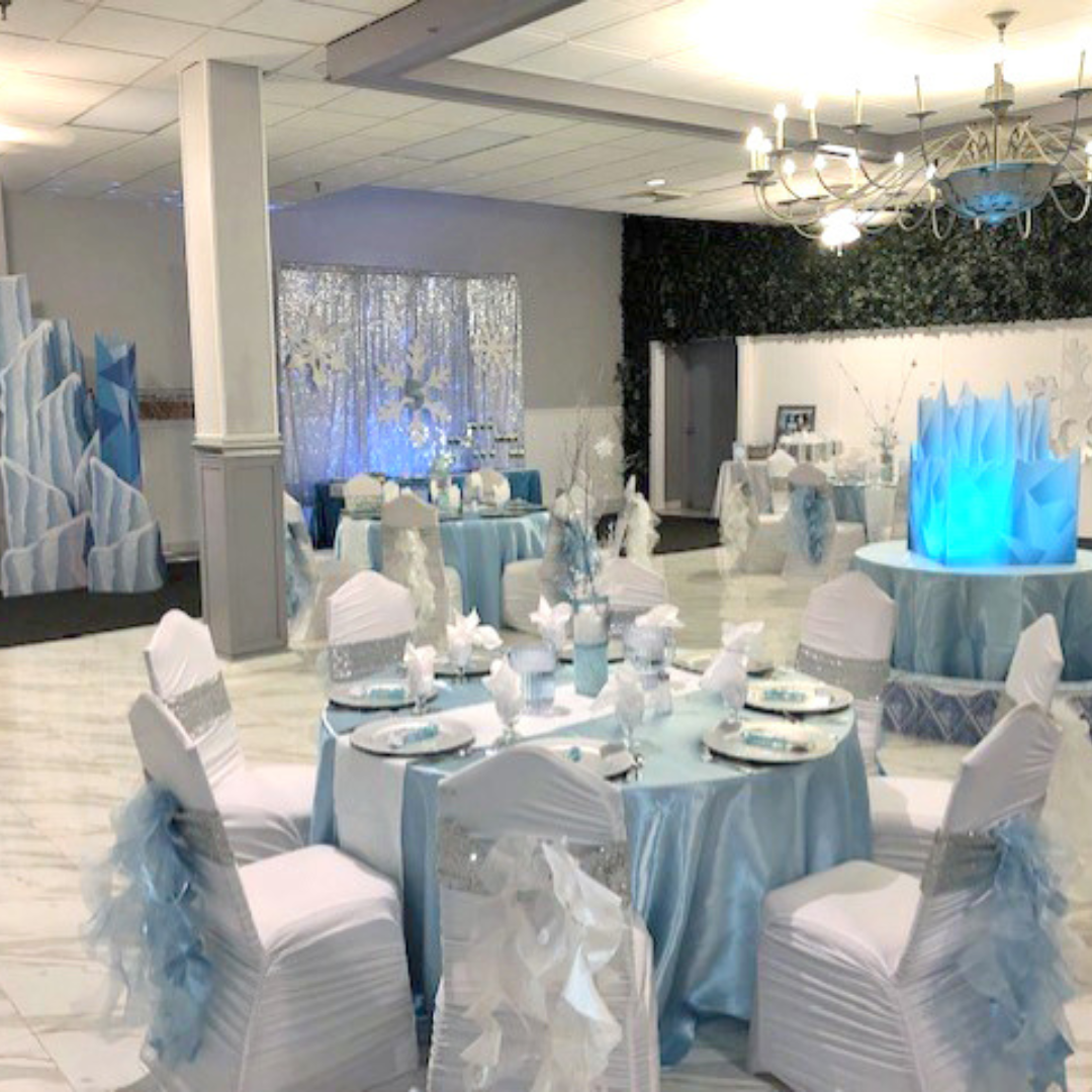 Sapphire Ballroom at Prestige Banquet Hall decorated in icy blue and silver with snowflake accents and dramatic centerpieces.